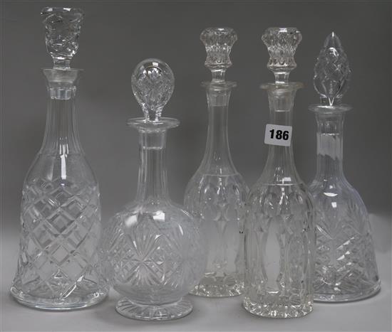 A pair of cut glass decanters and three others
